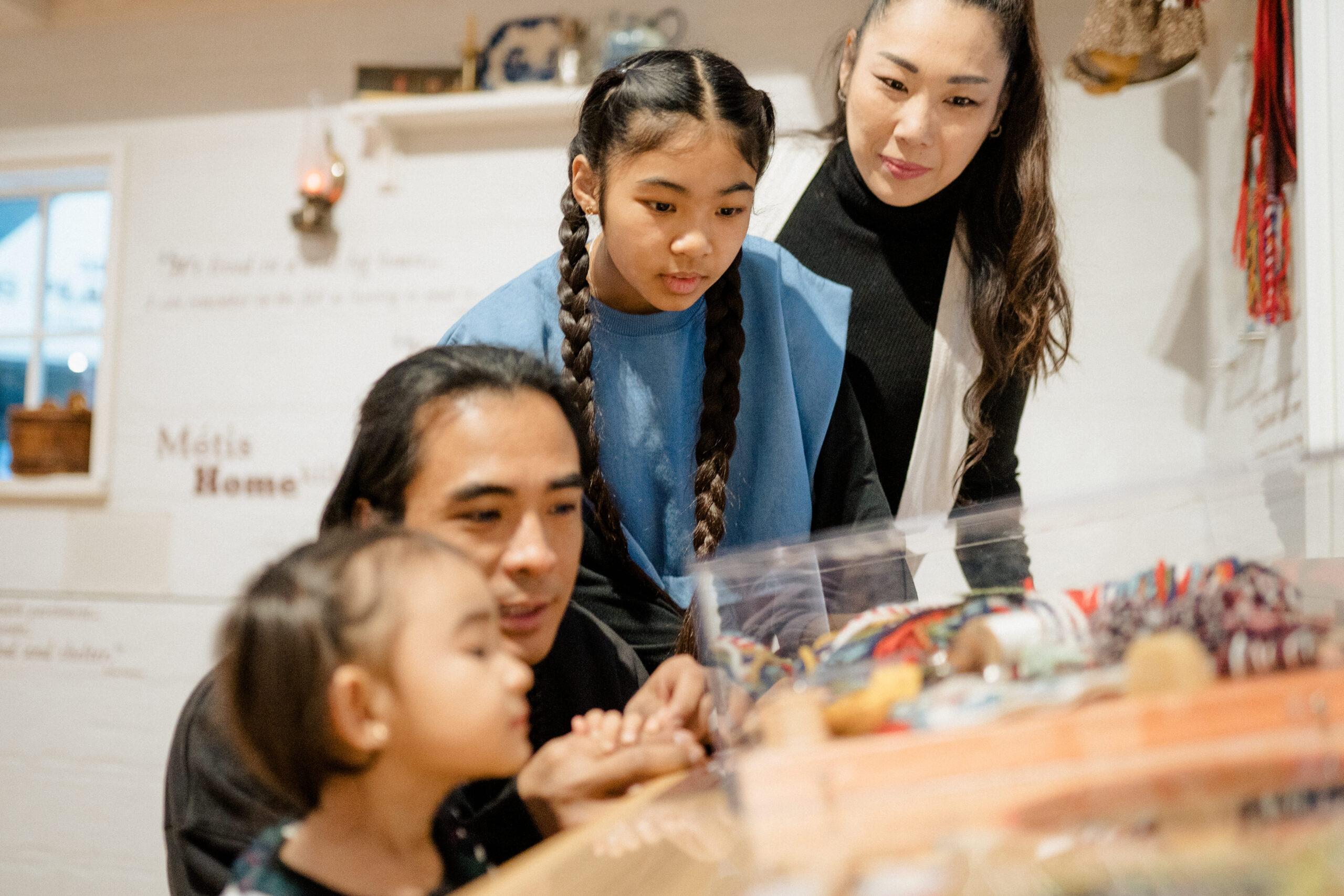 Family looking at artefact table