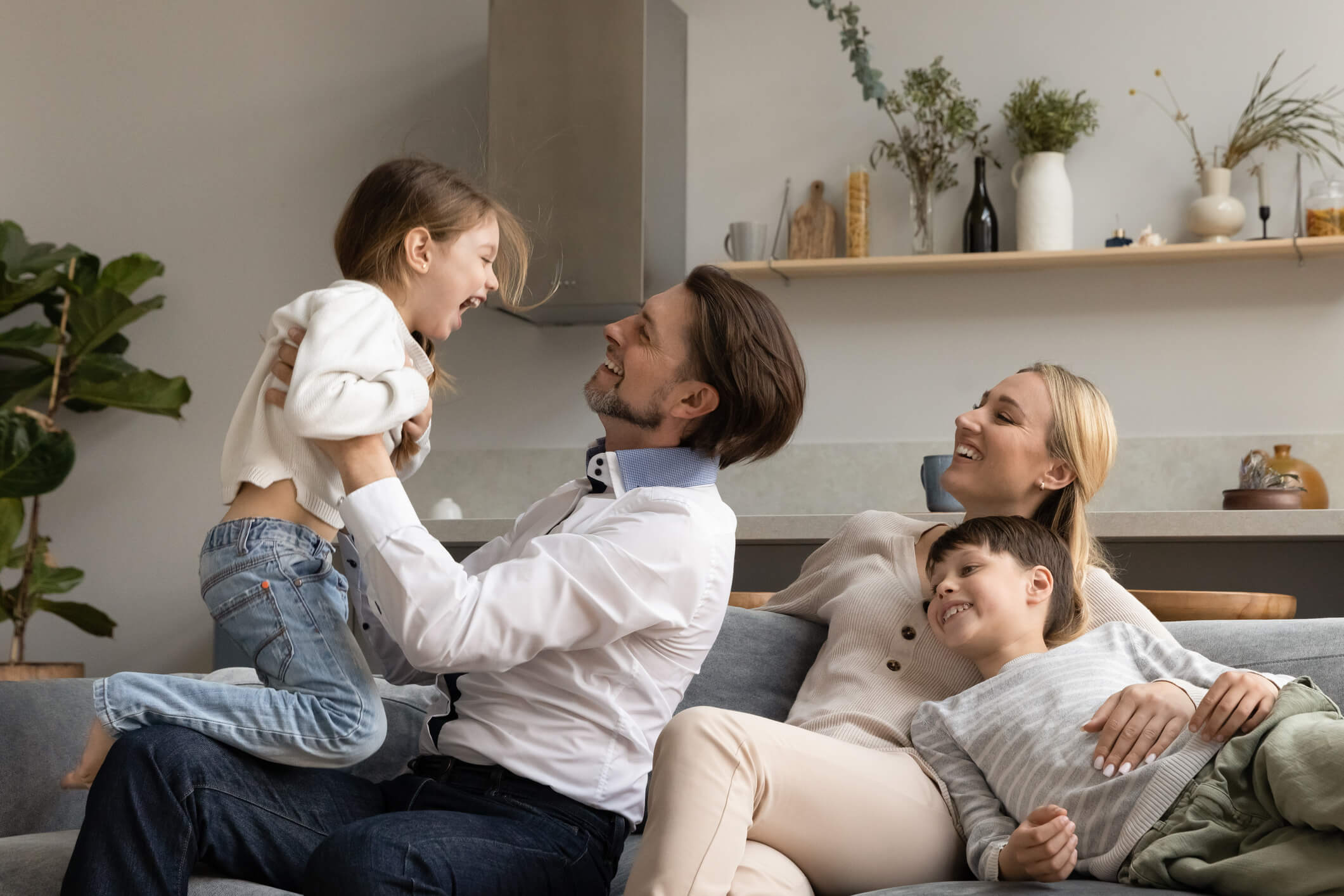 foster family on the couch having a joyful time