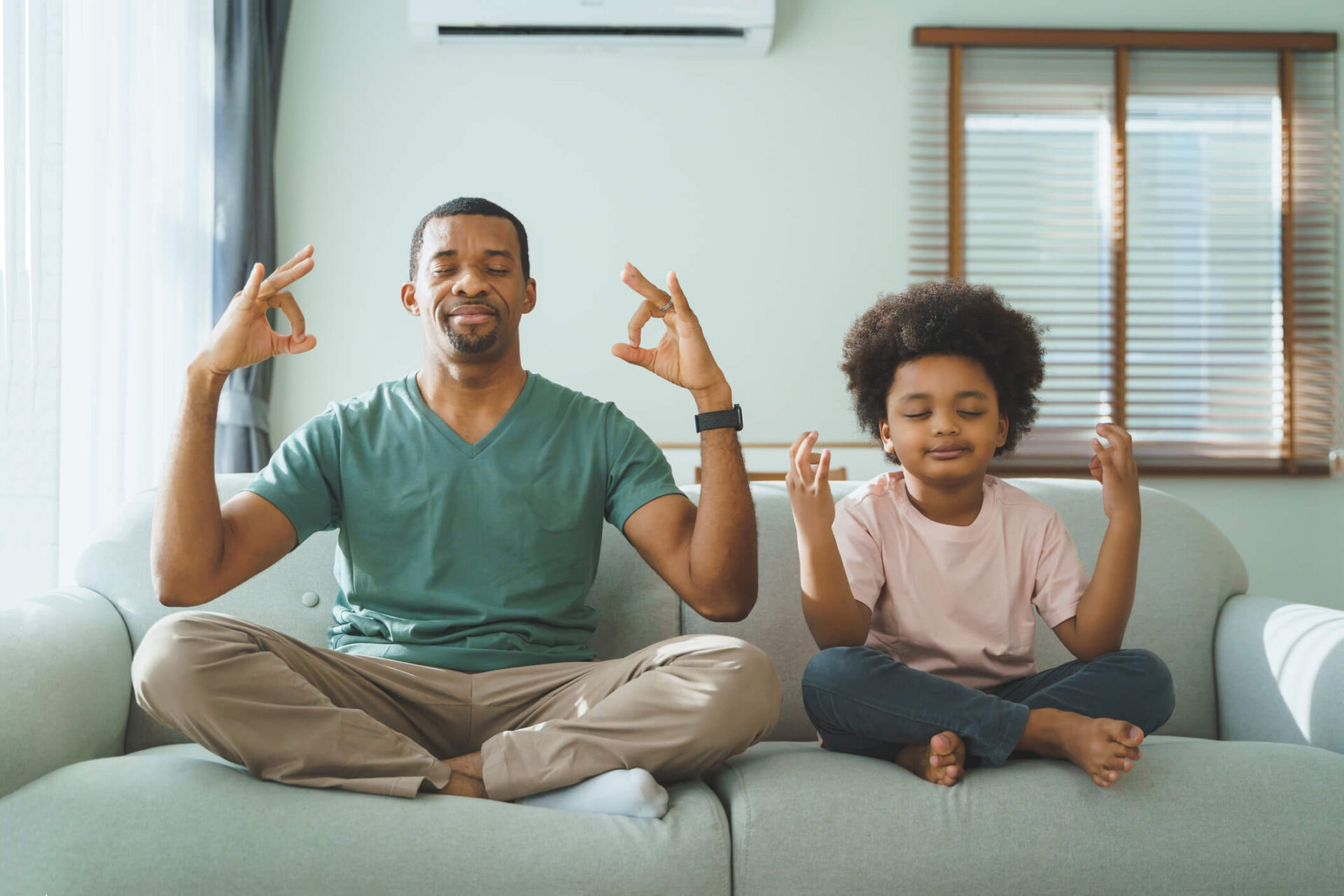 foster parent and child meditation on couch