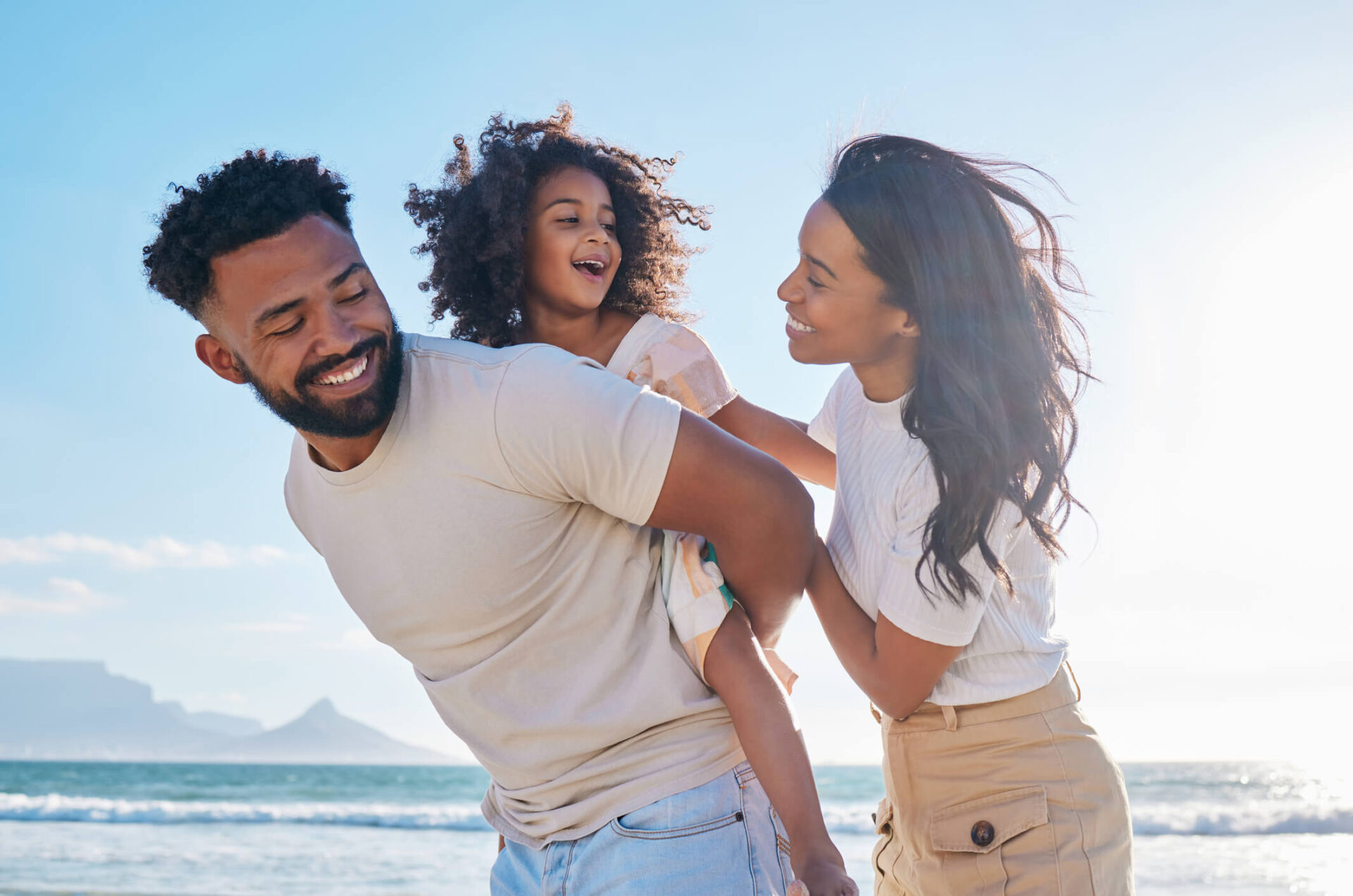 Foster family on beach walking and having fun laughing