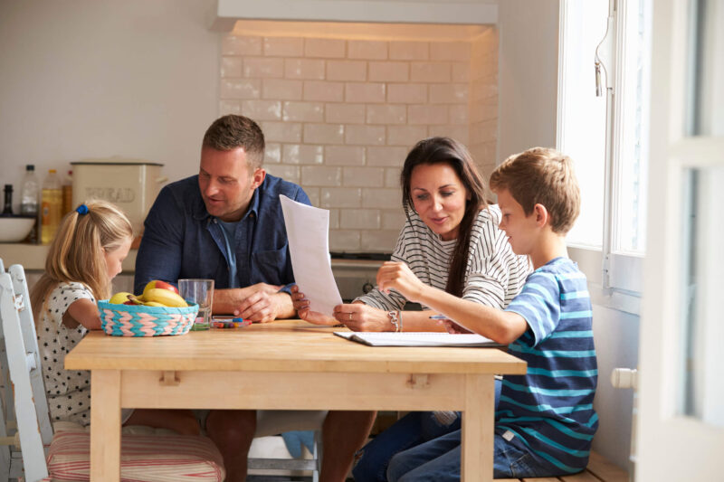 foster family helping children with home work